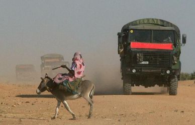 A woman rides a donkey in Chad as French troops patrol the border with Sudan