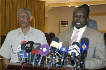 Nafi Ali Nafi, presidential advisor and member of the northern ruling National Congress Party, left, and Pagan Amum, secretary general of the main southern party and partner in unity government, the Sudan People's Liberation Movement, right, seen at a press conference in Khartoum (AP)