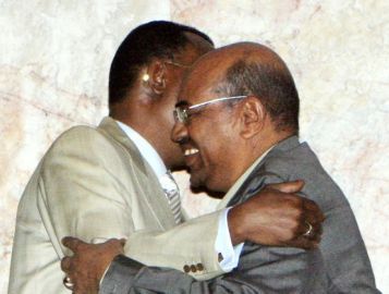 Sudanese President Omer Hassan al-Bashir (R) and his Chadian counterpart Idriss Deby embrace at the Friendship Hall in the capital Khartoum February 9, 2010 (Reuters)