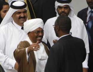 Sudanese President omer Al Bashir (C) moves to greet Khalil Ibrahim, leader of the rebel group Justice and Equality Movement (JEM), after the signing of a framework agreement in Doha February 23, 2010. (Reuters)