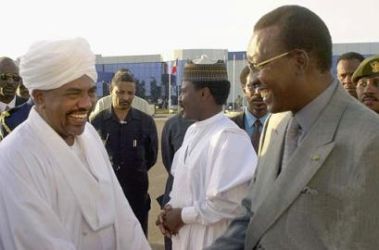 Visiting president Deby and president Al-Bashir shake hands in Khartoum on December 10 2003 (AFP)