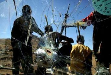 SLA rebels ride on the front of a truck with a bullet-ridden windscreen into the mountain village of Deribat in South Darfur state in western Sudan November 16, 2004. (Reuters)