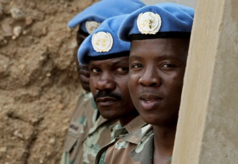 In this photograph made available by Albany Associates, UNAMID troops from South Africa, stand at ease during a visit by the Force commander to the Kutum Mission's Team Group Site in north-east Darfur.