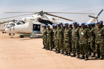 Members of UNAMID's Tactical Helicopter Unit stand by an M-35P helicopter in Nyala, South Darfur.  Photo Albert Gonzalez Farran (UNAMID)