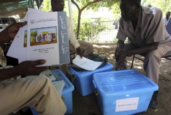 FILE - Sudanese officials show registration kits at the Elections High Committee compound in Khartoum November 1, 2009 (Reuters)