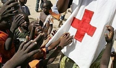 Children reach towards a Red Cross volunteer at an orphanage in Abeche, Chad, in 2007. (AFP)