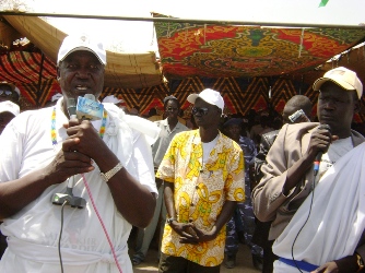 Kuol Manyang Juuk (L) speaks at a rally in Fangak on Thursday as Buoth Chuol (R), his campaign manager translate his speech into Nuer (Photo by Philip Thon Aleu -- ST)