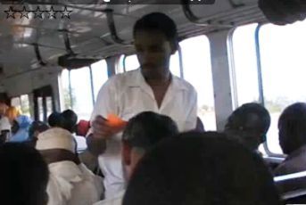 A Girifna member distributes leaflets inside one of the buses in the capital's transport.