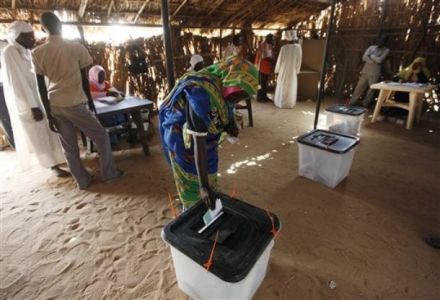 A Sudanese IDP woman casts her vote at a polling station in the refugee camp of Abou Shouk at the outskirts of the Darfur town of el Fasher, Sudan Sunday, April 11, 2010. (AP)