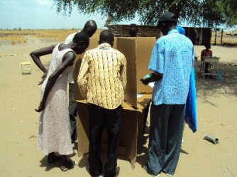 A photo showing illiterate voters being assisted at a polling station in Werkok on April 15, 2010 (ST)