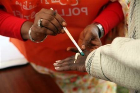 A poll official marks a voters hand with ink at the Sudan Embassy in Nairobi, Kenya, Sunday, April 11, 2010. (AP)