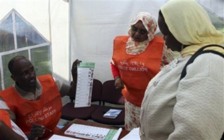 A polling official explains a Sudanese voter how to cast her vote at the Sudan Embassy in Nairobi, Kenya, Sunday, April 11, 2010. (AP)