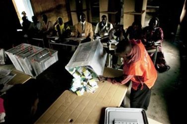 A polling station official empties a ballot box for the start of counting in Juba, southern Sudan on Friday, April 16, 2010. (AP)