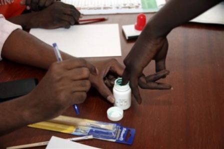 A voter dips his finger in the ink at the Sudan Embassy in Nairobi, Kenya, Sunday, April 11, 2010. (AP)