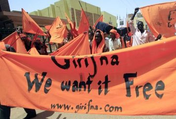 FILE - Activists of Grifna (We Are Fed Up), an opposition youth movement, carry banners during a demonstration outside the National Election Commission in Sudan's capital Khartoum April 6, 2010. (Reuters)