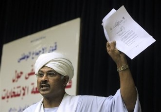 Mubarak al-Fadil, head of the Umma Renewal and Reform Party, and a former candidate for Sudanese Presidency, waves a document extolling one of the many violations his party had considered when it pulled out of contesting the elections in Khartoum, Sudan, Friday, April 9, 2010 (AP)