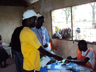 Polling official gives out ballot card to a voter in Makuach Payam on Sunday (ST)