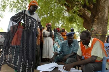 Southern Sudanese women check voting information with an official at a polling station in Juba, April 11, 2010. (UNMIS)