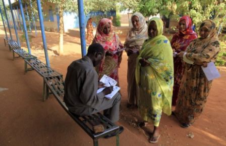 voting information with an official at a polling station in Omdurman, west of Khartoum April 11, 2010 (Reuters)