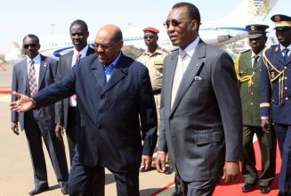 Sudan's President Omer Hassan Al-Bashir (front L) welcomes his Chadian counterpart Idriss Deby (front R) at Khartoum airport February 8, 2010. (Reuters)