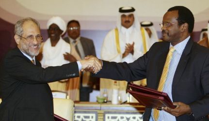 Ghazi Salah Eddin (L), adviser to Sudan's President Omar Hassan al-Bashir, shakes hands with Al-Tijani Al-Sissi of the Liberation and Justice Movement (LJM) after signing a truce in Doha March 18, 2010. Reuters