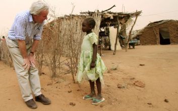 U.N. Under-Secretary General John Holmes talks to a girl at El Sereif IDPs camp in the South Darfur town of Nyala May 29, 2010 (Reuters)