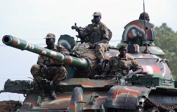 Southern Sudanese soldiers from the Sudan People's Liberation Army (SPLA) sit on top of a tank (Getty Images)