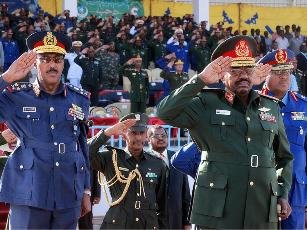 FILE - Sudanese President Omer al-Bashir (C) salutes flanked by Sudanese Air Force officers at a military function in Khartoum (AFP)
