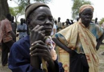 People displaced by fighting in Abyei wait to be registered at a UN WFP distribution point in the village of Abathok May 19, 2008. (Reuters)