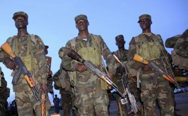 Ugandan army soldiers walk at their military air base in Entebbe, 42 km (26 miles) south of Uganda's capital Kampala, March 15, 2009. (Reuters)