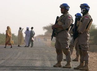 Members of the Indonesian peacekeeping force from the United Nations-African Union Mission in Darfur (UNAMID) stand guard at ZamZam camp for internally displaced people in Al Fasher, northern Darfur April 13, 2010 (Reuters)