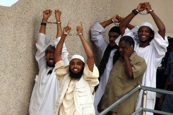 Four Sudanese convicts lift their handcuffs as they are escorted out of the courtroom in the capital Khartoum, June 24, 2009 (Reuters)