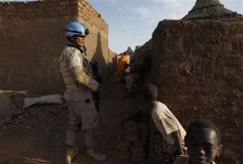 An UNAMID peacekeeper patrols the Abu Shouk refugee camp, out side the Darfur town of al-Fasher, Sudan, March 21, 2009 (AP)