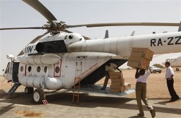 FILE - Sudanese workers load polling station kits into a waiting helicopter of the United Nations African Union Mission in Darfur, UNAMID to be transported to the voting center of the north Darfur town of Mellit, in the airport of el Fasher, Darfur, Sudan Thursday, April 8, 2010 (AP)