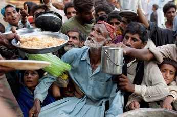 Desperate flood victims scramble for some rice given out by the Pakistan military at a tent camp August 19, 2010 in Sukkur, Pakistan (AFP)