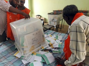 A staff member for Sudan's National Elections Commission (NEC) empties a ballot box at a polling station in the Sudanese capital, Khartoum, on 16 April 2010 (Photo: Reuters)