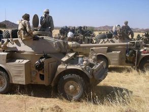 Chadian soldiers riding on armoured vehicles near the border with Sudan (AFP)