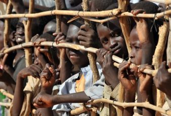 Sudanese refugee children press up against a fence in Djabal refugee camp near Goz Beida southern Chad on March 15, 2009. (Getty)
