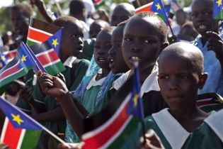 Young southern Sudanese students wave flags during a march for southern independence in Juba on Wednesday, June 9, 2010. (Reuters)