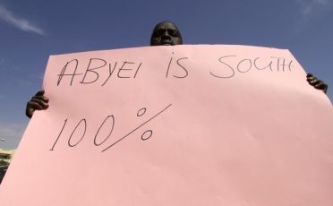 A man from the Dinka tribe holds a placard during a demonstration calling for the immediate formation of the Abyei referendum commission outside the United Nations headquarters in Khartoum September 23, 2010 (Reuters)
