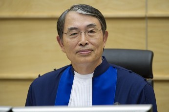 Judge Sang-Hyun Song smiles during the verdict in the case of Congolese warlord Thomas Lubanga in the International Criminal Court in The Hague, October 8, 2010 (AFP)