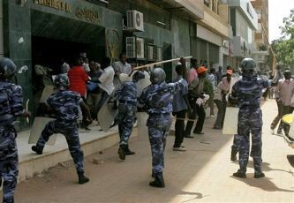 Sudanese police use batons to disperse demonstrators who were calling for independence for south Sudan during a pro-unity rally in Khartoum on October 9, 2010 (AFP)