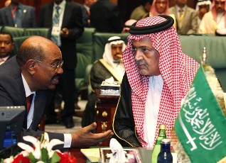 Saudi Arabia's Foreign Minister Prince Saud Al-Faisal (R) talks to Sudan's President Omar Hassan al-Bashir during the closing session of the Arab League summit in Sirte October 9, 2010 (Reuters)