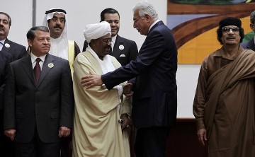 FILE - Egyptian Prime Minister Ahmed Nazif (2nd R) greets Sudan's President Omer Hassan al-Bashir before they take a family photograph at the Arab League summit in Sirte March 27, 2010