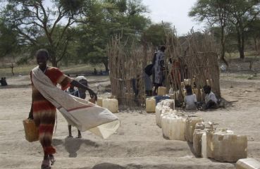 A displaced young girl from Abyei collects water near a school where she is sheltering in Agok, southern Sudan, June 7, 2008.  (Reuters)