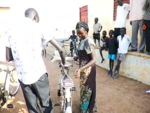 A female teacher from Guit countyrecieves a bicycle donated by the Windle Trust, Unity State, South Sudan. Nov. 25, 2010 (ST)
