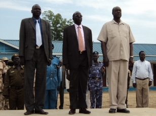 Gier Chuang Aluong, GoSS minister of internal affairs (center), Jonglei state governor Kuol Manyang Juuk (right) and Gabriel Duop, Jonglei ministet of law enforcement (left) standing at a guard of honor at police headquarters in Bor, Nov. 9, 2010 (ST)