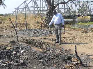 Southern Sudanese official pointing to the remains of the recent bombing near Kiir Adem bridge linking south Darfur and Northern Bahre el Ghazal (ST)