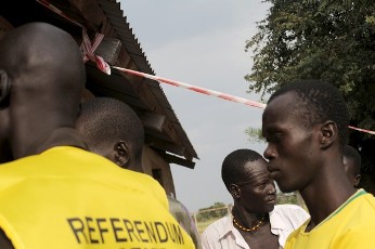 Residents (R) of the remote south central Southern Sudan village of Nyal line up to register their names at a local school being used as a voter registration office on November 15, 2010 (AFP)