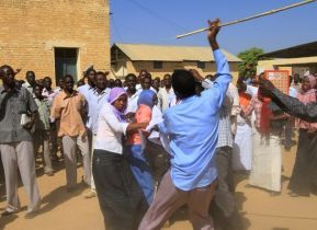 A Sudanese man holding a cane scuffles with university students after clashes erupted in a protest during the visit of Darfur mediators in Zalingeion Dec 1, 2010 (Getty)